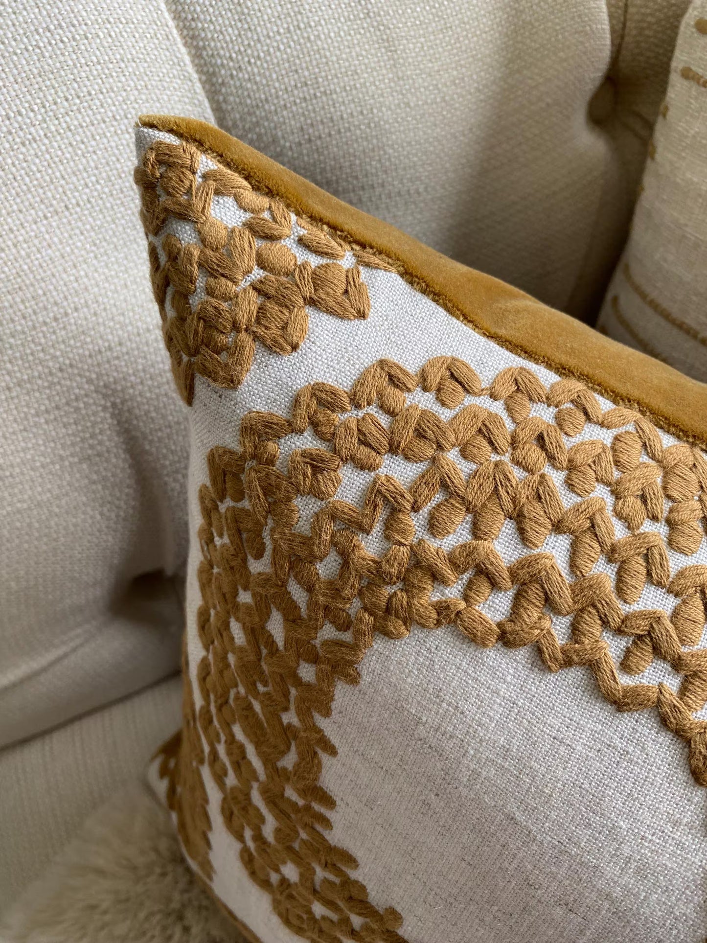 SAFI- Handmade cushion cover with cinnamon embroidered circular motifs on cream background.
